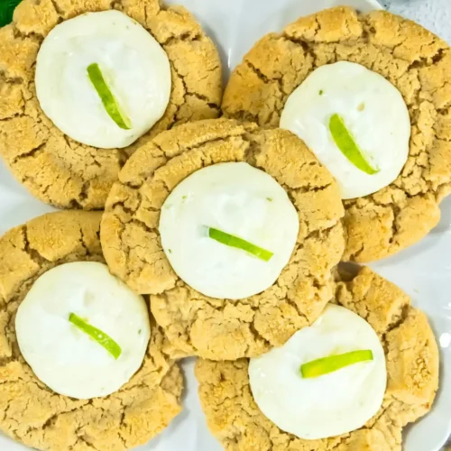 Key Lime Pie Cookies Inspired by Crumble Key lime cheesecake cookies with creamy frosting on plate