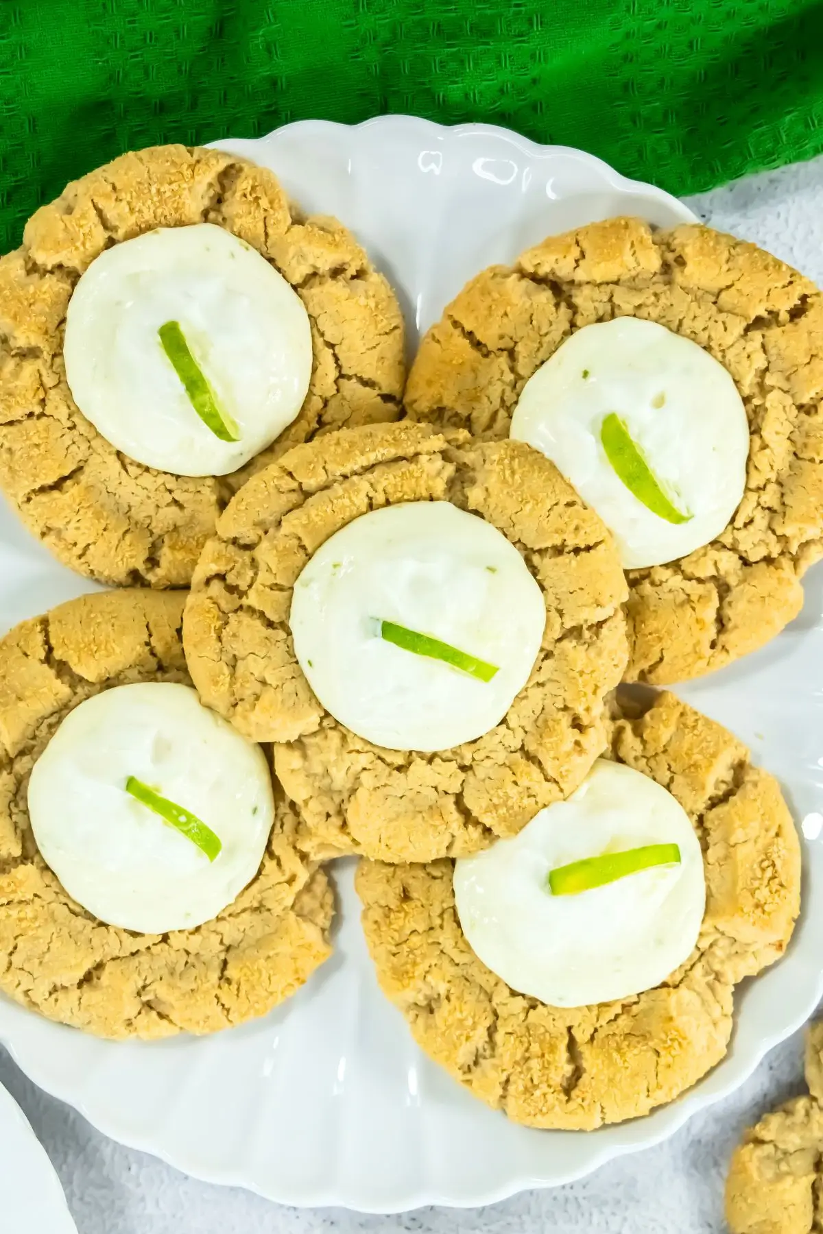 Key Lime Pie Cookies Inspired by Crumble Key lime cheesecake cookies with creamy frosting on plate