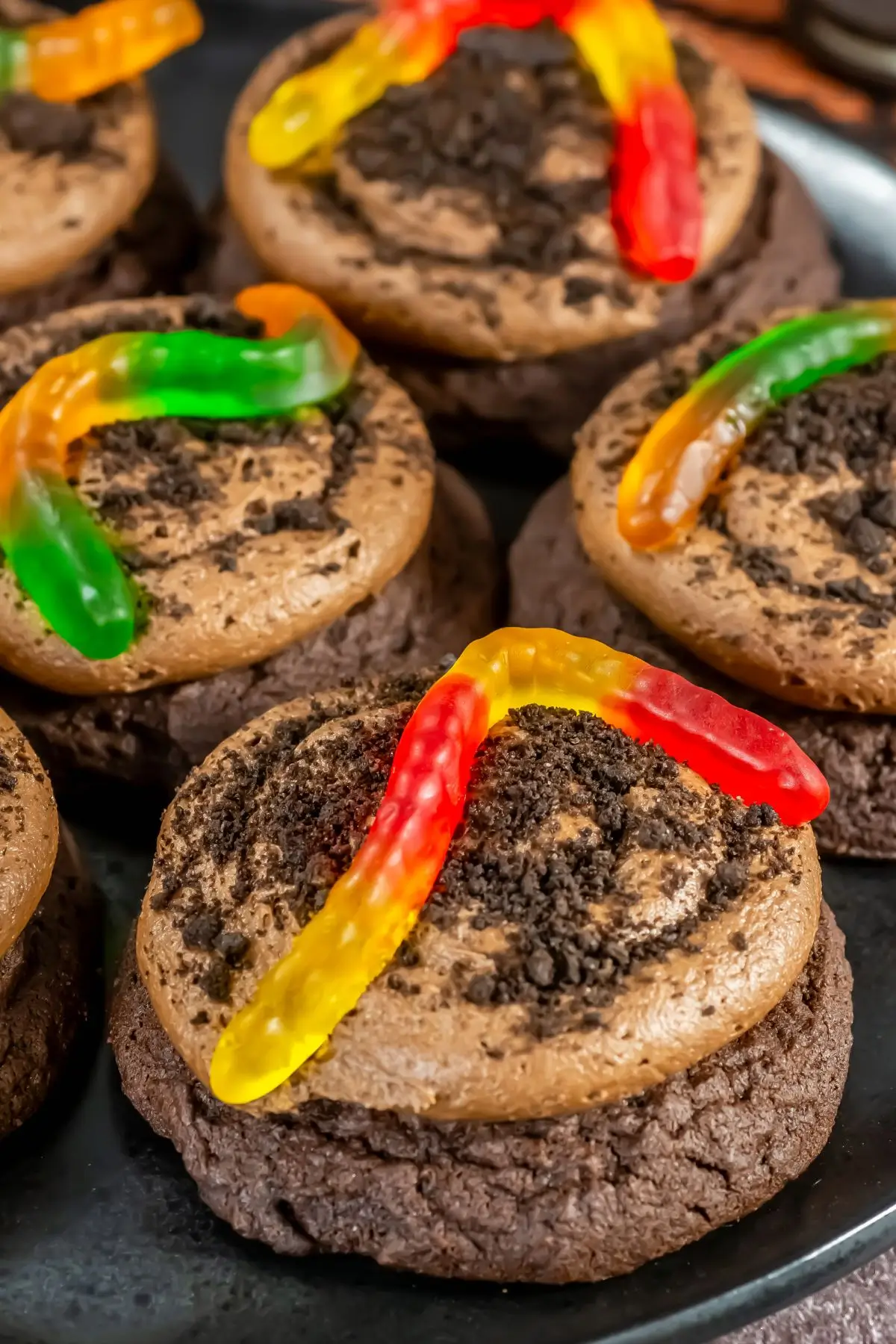 Chocolate dirt cookies with frosting, Oreo crumbs, and gummy worms