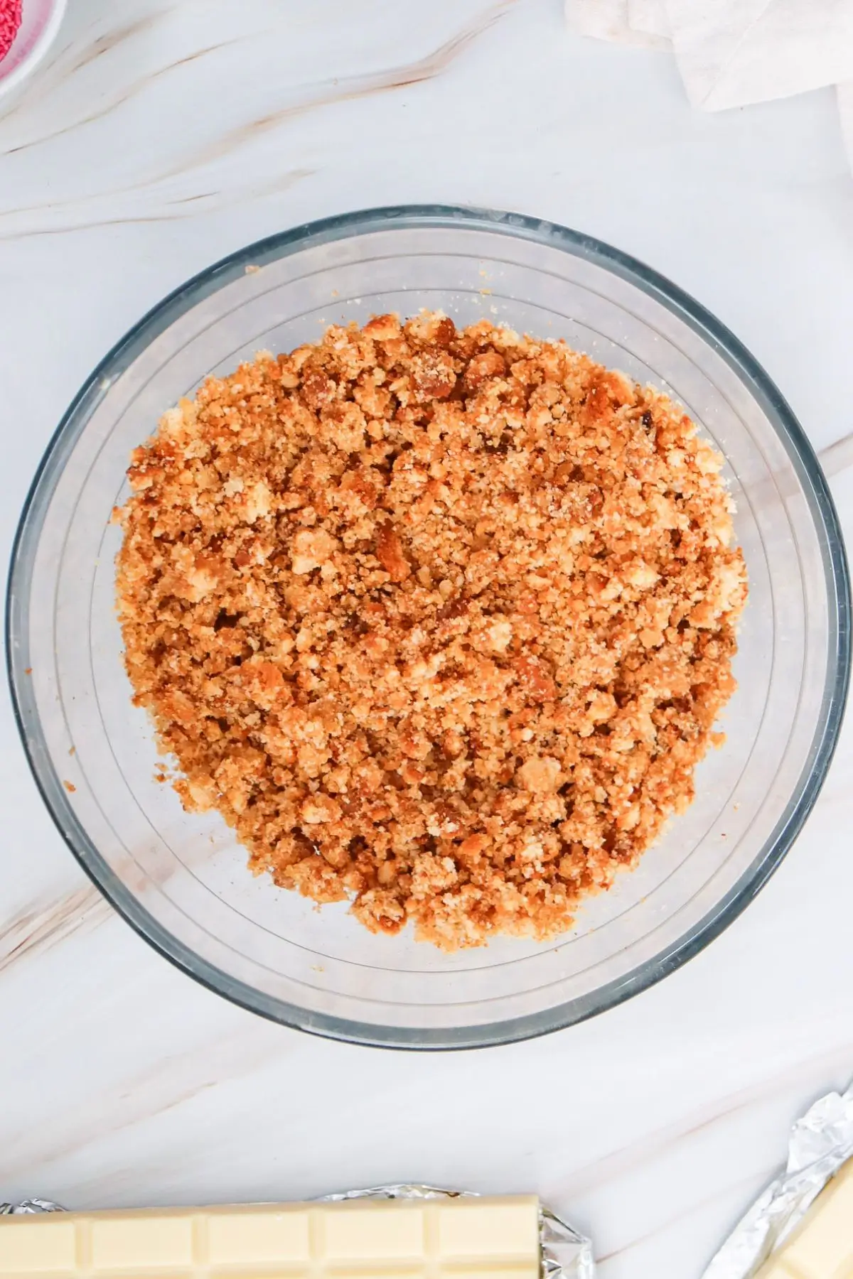 Crumbled cake in a mixing bowl.