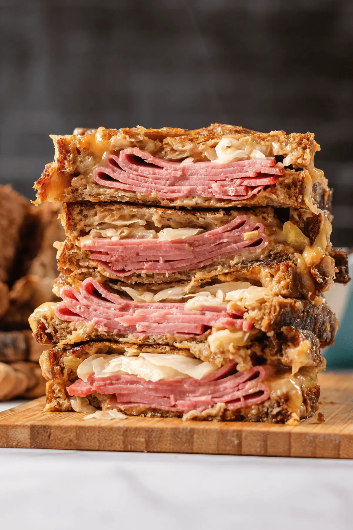 Stacked Reuben sandwich with corned beef, sauerkraut, Swiss cheese on toasted rye