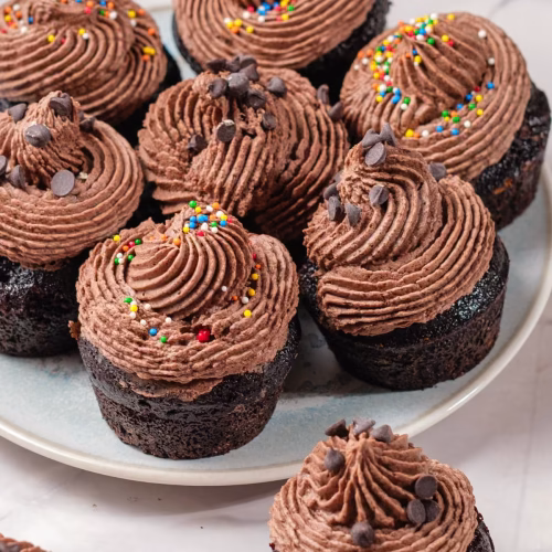 super moist chocolate cupcakes with ganache and chocolate chips and colorful sprinkles