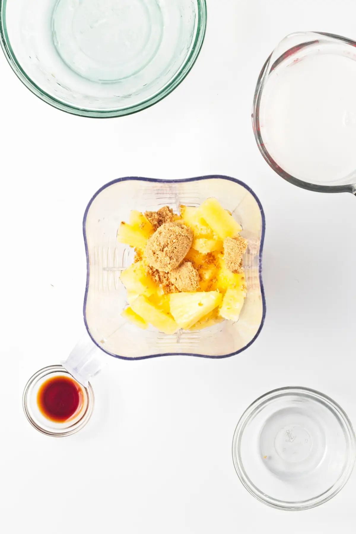 Pineapple and dark brown sugar in a blender for rumless pina colada popsicles