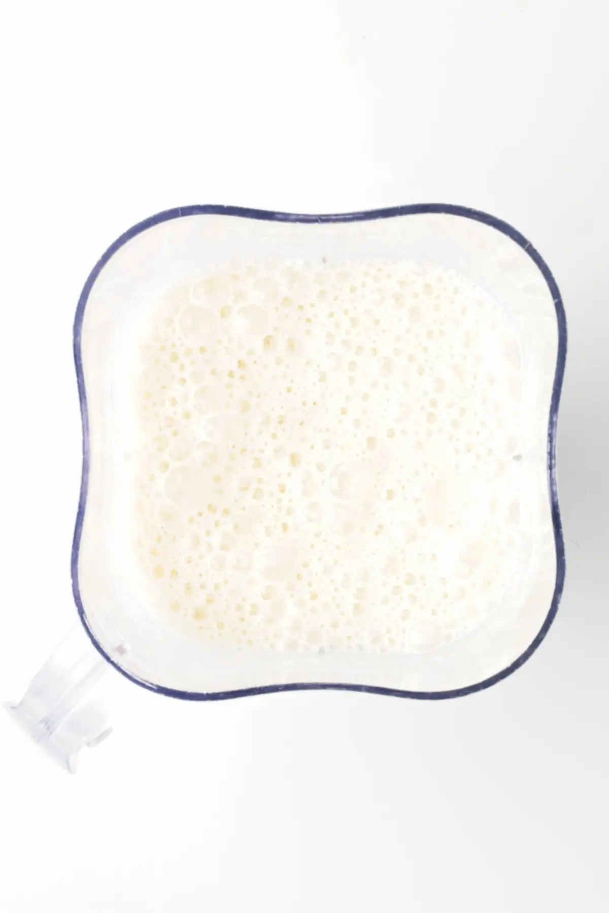 Blended coconut milk and pineapple mixture in a blender