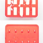 Pina colada popsicle mixture poured into red popsicle molds