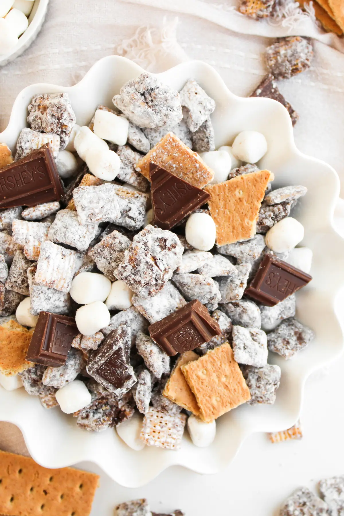 S’mores Muddy Buddies Recipe (S’mores Puppy Chow) Finished S'mores muddy buddies in a white serving bowl