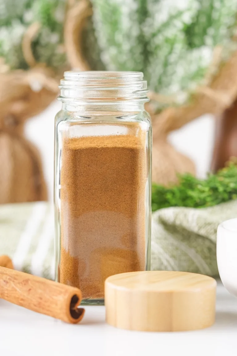 Homemade allspice substitute stored in a clear spice jar.