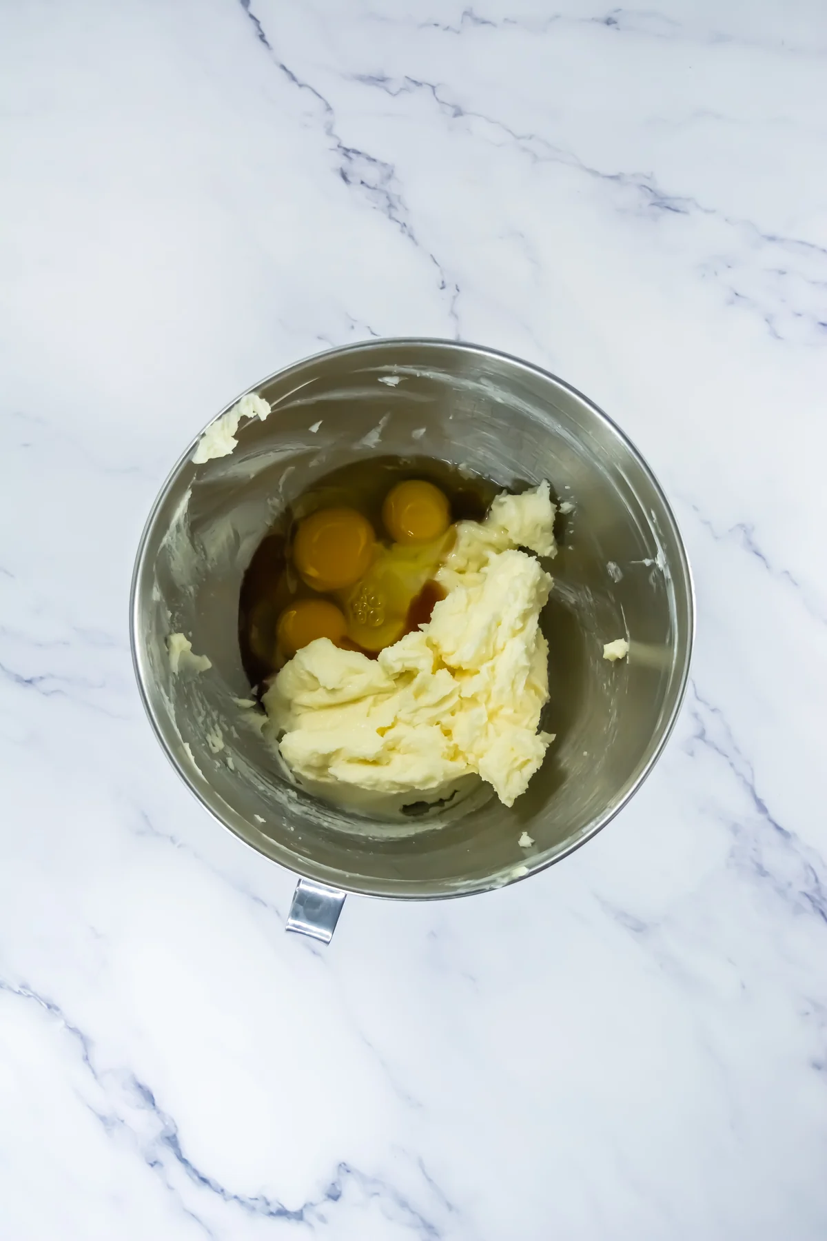 Eggs and vanilla added to creamed butter for churro cookie dough