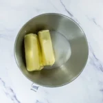 Butter and sugar in a stand mixer bowl for churro cookie dough