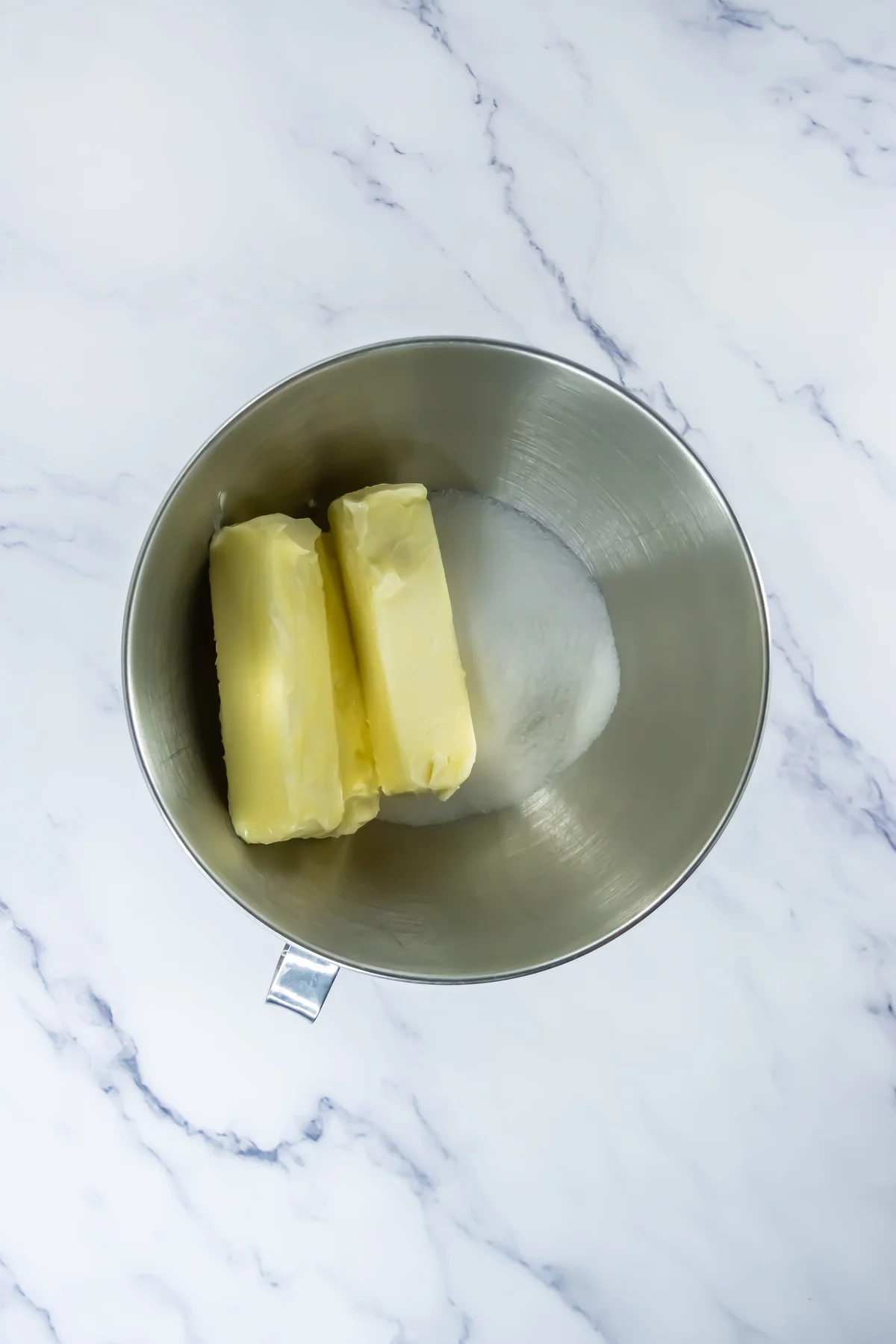 Butter and sugar in a stand mixer bowl for churro cookie dough