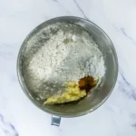Flour, cinnamon, and baking powder added to churro cookie dough