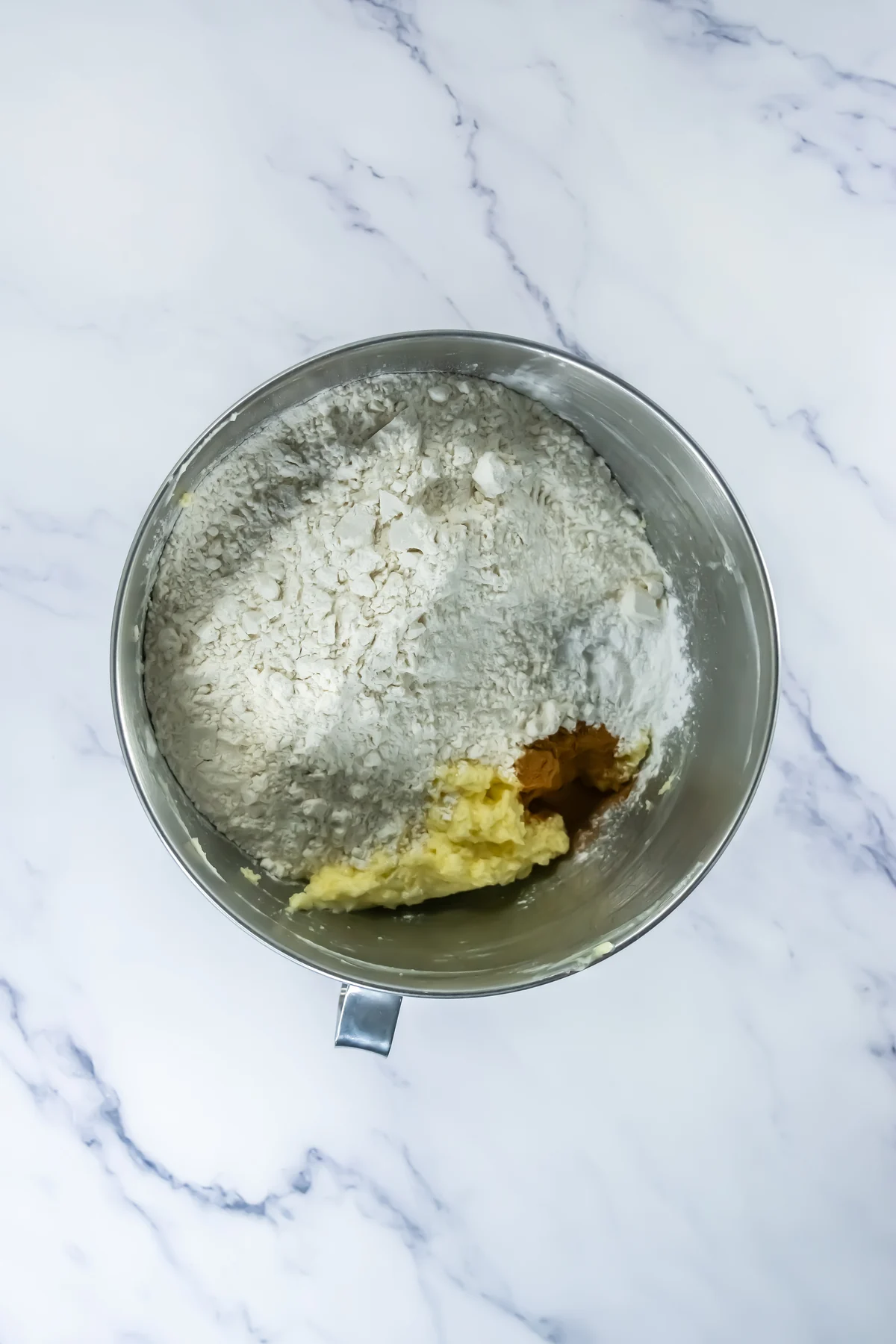 Flour, cinnamon, and baking powder added to churro cookie dough