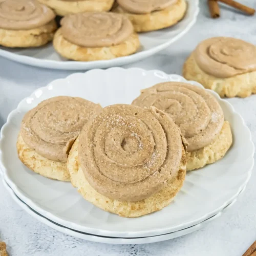 Copycat Crumbl churro cookies with cinnamon frosting on a white plate
