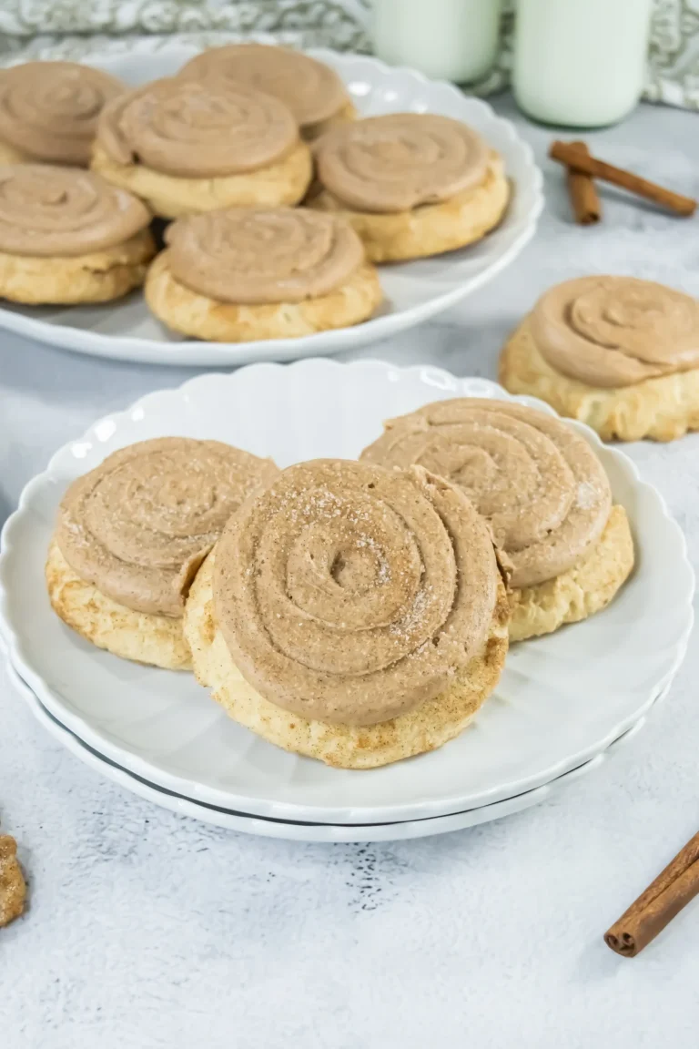 Copycat Crumbl churro cookies with cinnamon frosting on a white plate