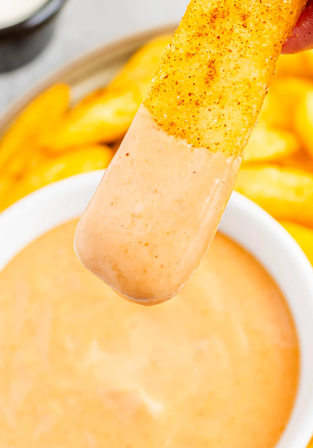 A seasoned fry coated with creamy orange campfire sauce.