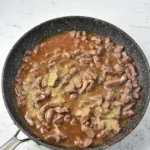 Venison simmering with beef broth and seasoning