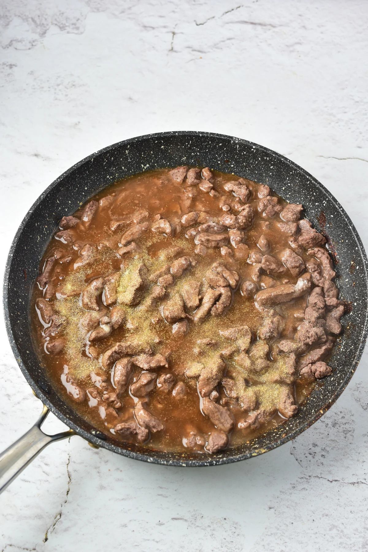 Venison simmering with beef broth and seasoning