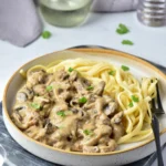 Creamy venison stroganoff with mushrooms served over egg noodles
