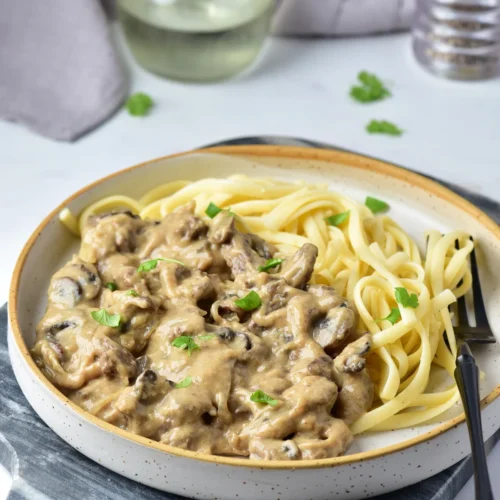 Creamy venison stroganoff with mushrooms served over egg noodles
