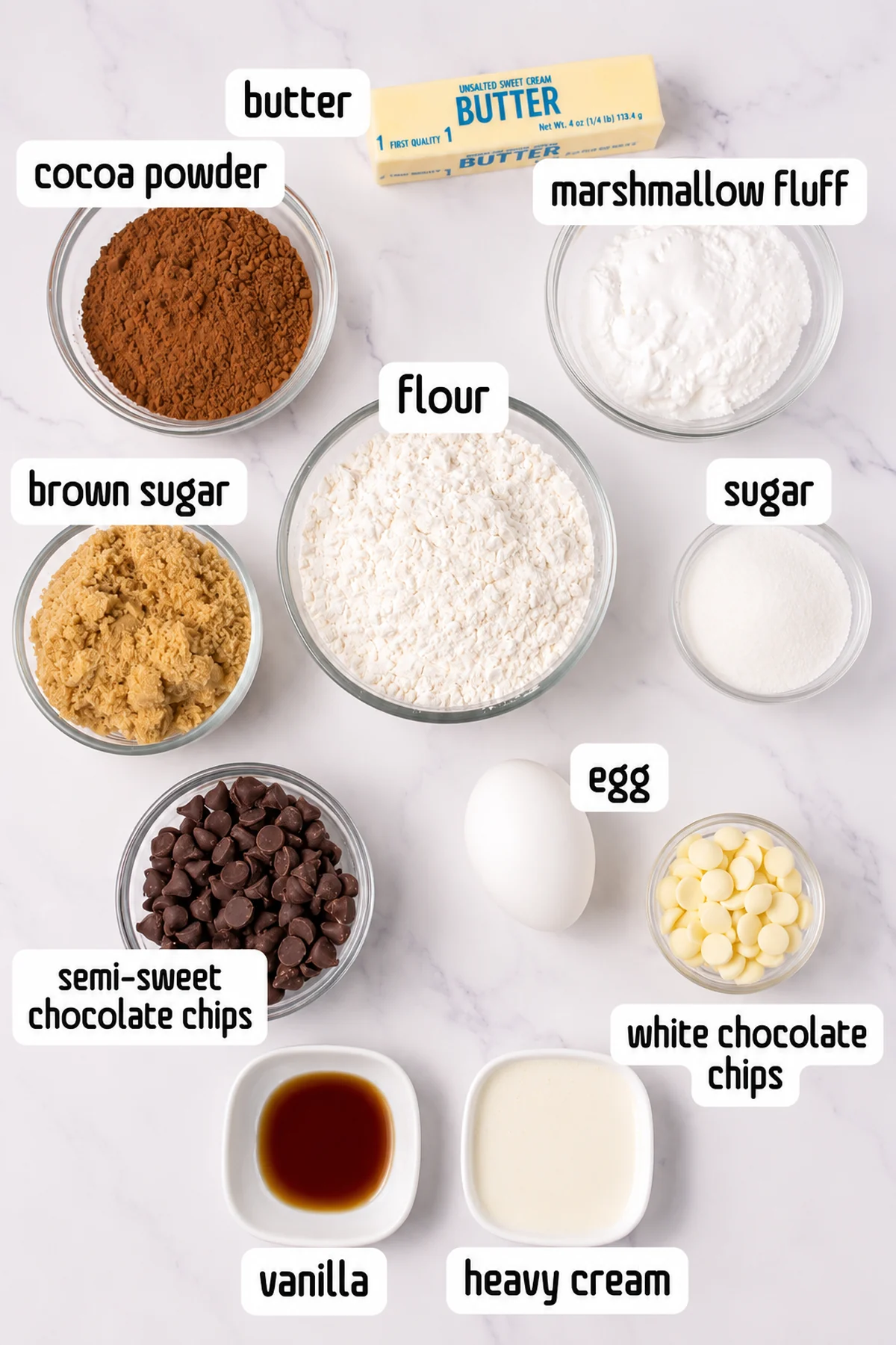 Ingredients for Crumbl copycat chocolate mallow cupcake cookies labeled on a marble surface.