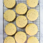 Crumbl Copycat Twix Cookies With Caramel and Toffee Large baked toffee cookies cooling on a wire rack before topping.