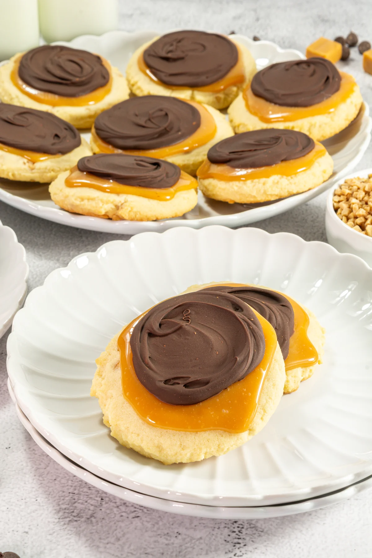 Crumbl Copycat Twix Cookies With Caramel and Toffee Single oversized chocolate caramel cookie served on a white dessert plate.