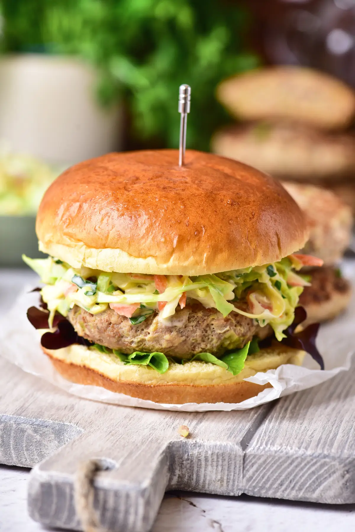 Ground chicken burger with cabbage slaw on a bun