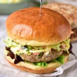 Ground chicken burger with hidden cabbage served on a bun