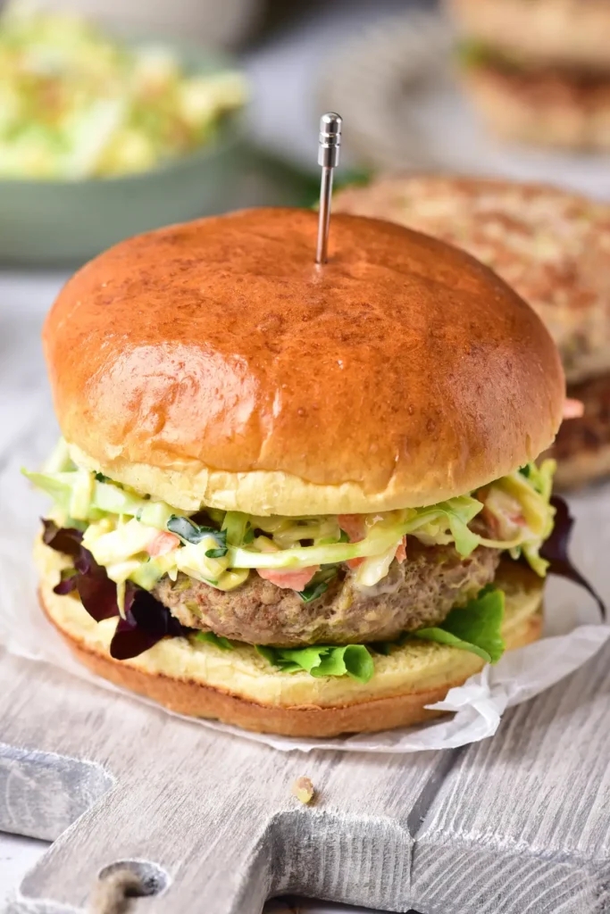 Ground chicken burger with hidden cabbage served on a bun