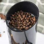 How to Make Ground Allspice From Whole Berries Whole allspice berries in an electric spice grinder.