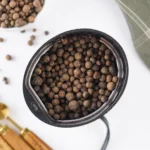 How to Make Ground Allspice From Whole Berries Whole allspice berries ready to grind in a spice grinder.