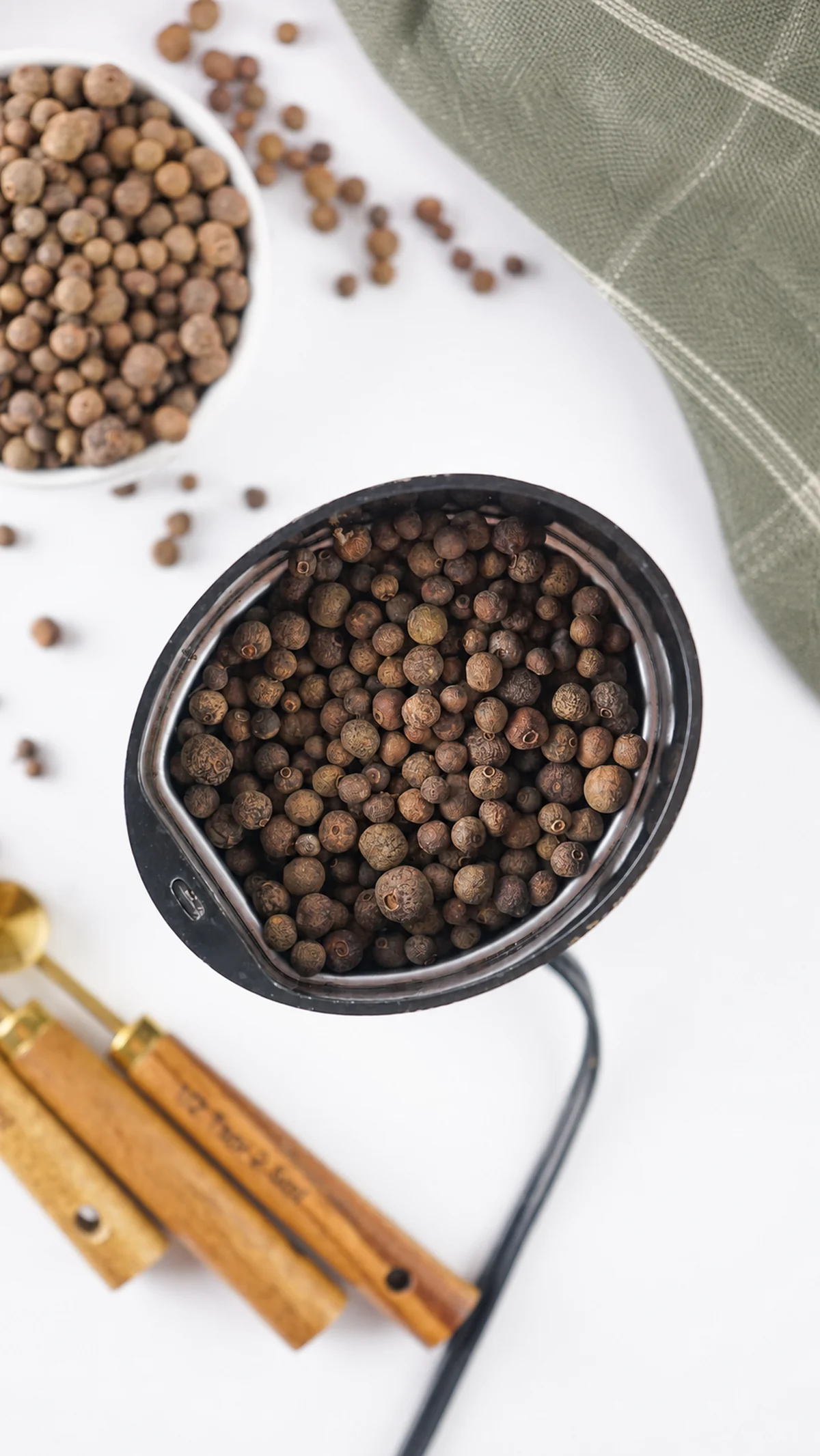 How to Make Ground Allspice From Whole Berries Whole allspice berries ready to grind in a spice grinder.