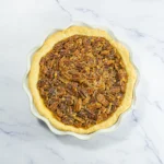 Finished bourbon pecan pie cooling after baking.