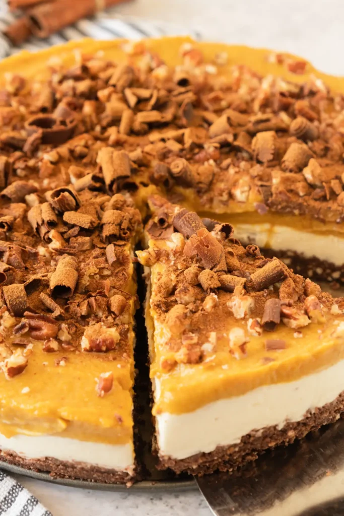 Layered no bake pumpkin cheesecake with chocolate crust and mascarpone filling.