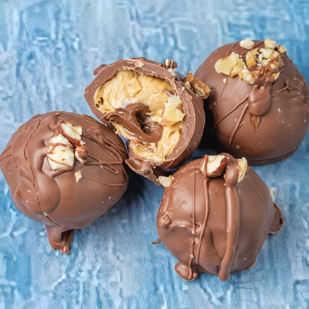 Close-up of chocolate peanut butter balls with a creamy Nutella center.