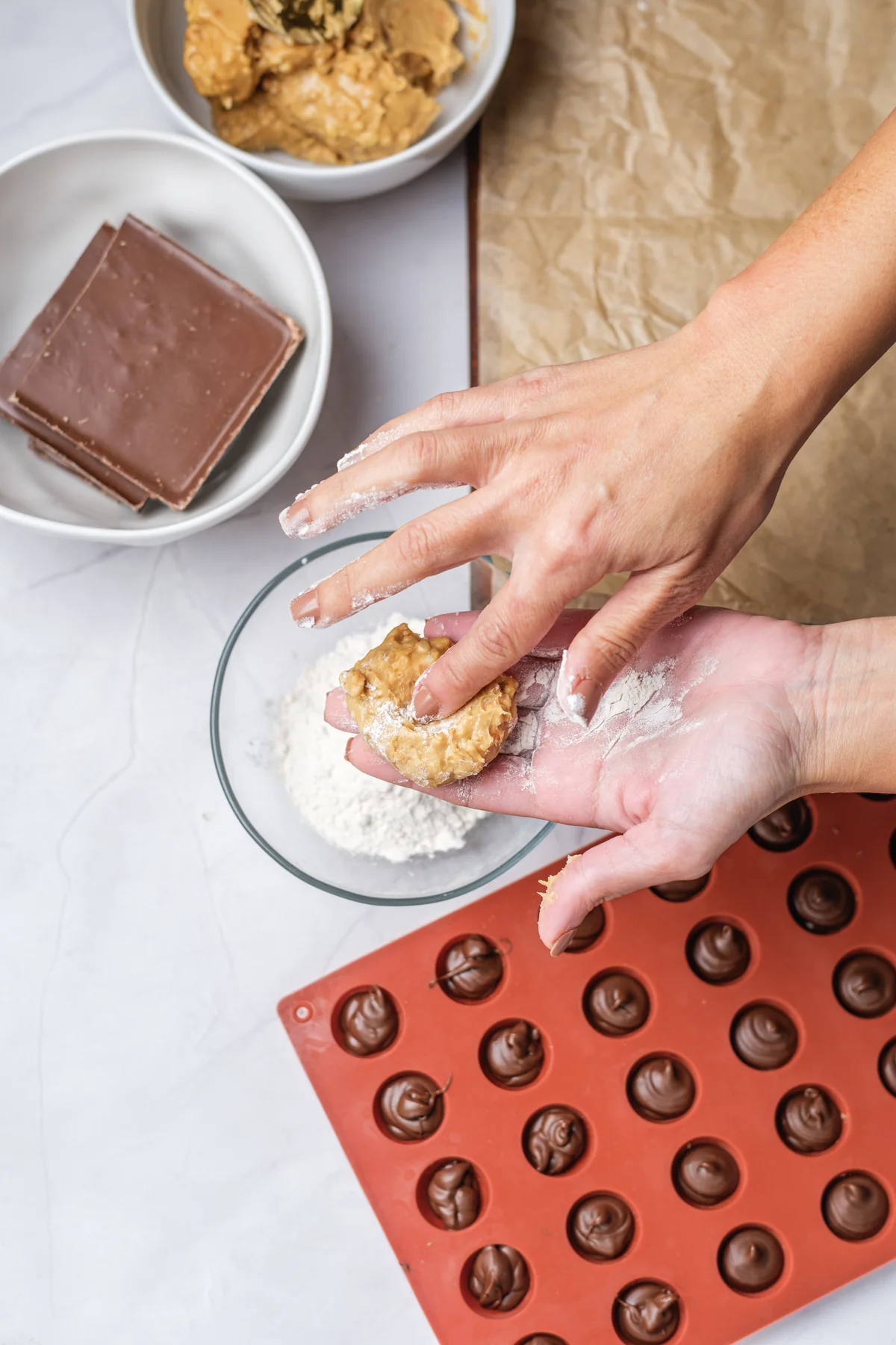 Peanut butter mixture flattened by hand before wrapping around frozen Nutella.