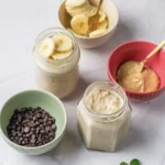 Peanut Butter Banana Overnight Oats Without Yogurt Banana slices, peanut butter, and chocolate chips added to jars of overnight oats.