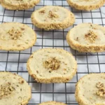 Baked pecan shortbread cookies cooling on a wire rack.