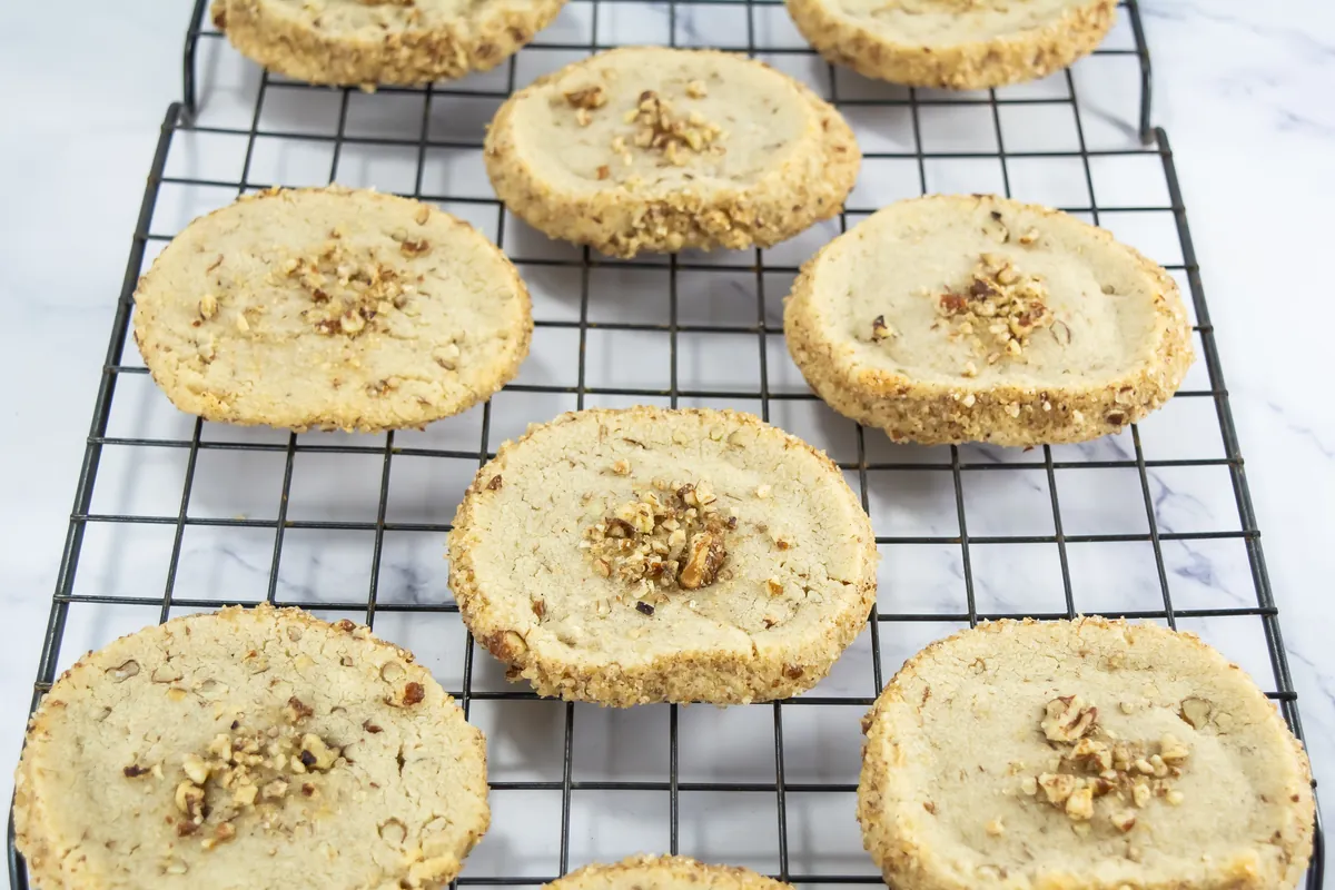 Baked pecan shortbread cookies cooling on a wire rack.