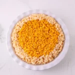 Pumpkin Rice Krispie filling pressed into the cereal crust before slicing.