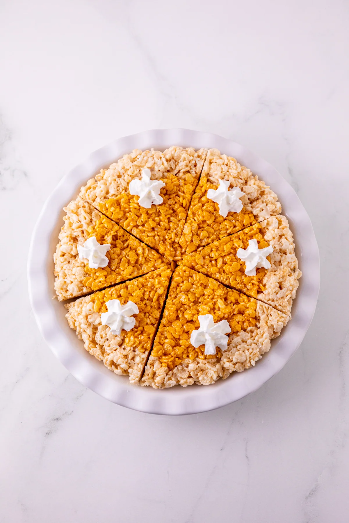 Overhead view of Pumpkin Pie Rice Krispie Treats sliced into six wedges.