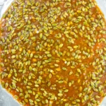 Hot pumpkin seed brittle spread thinly on a lined baking sheet to cool.