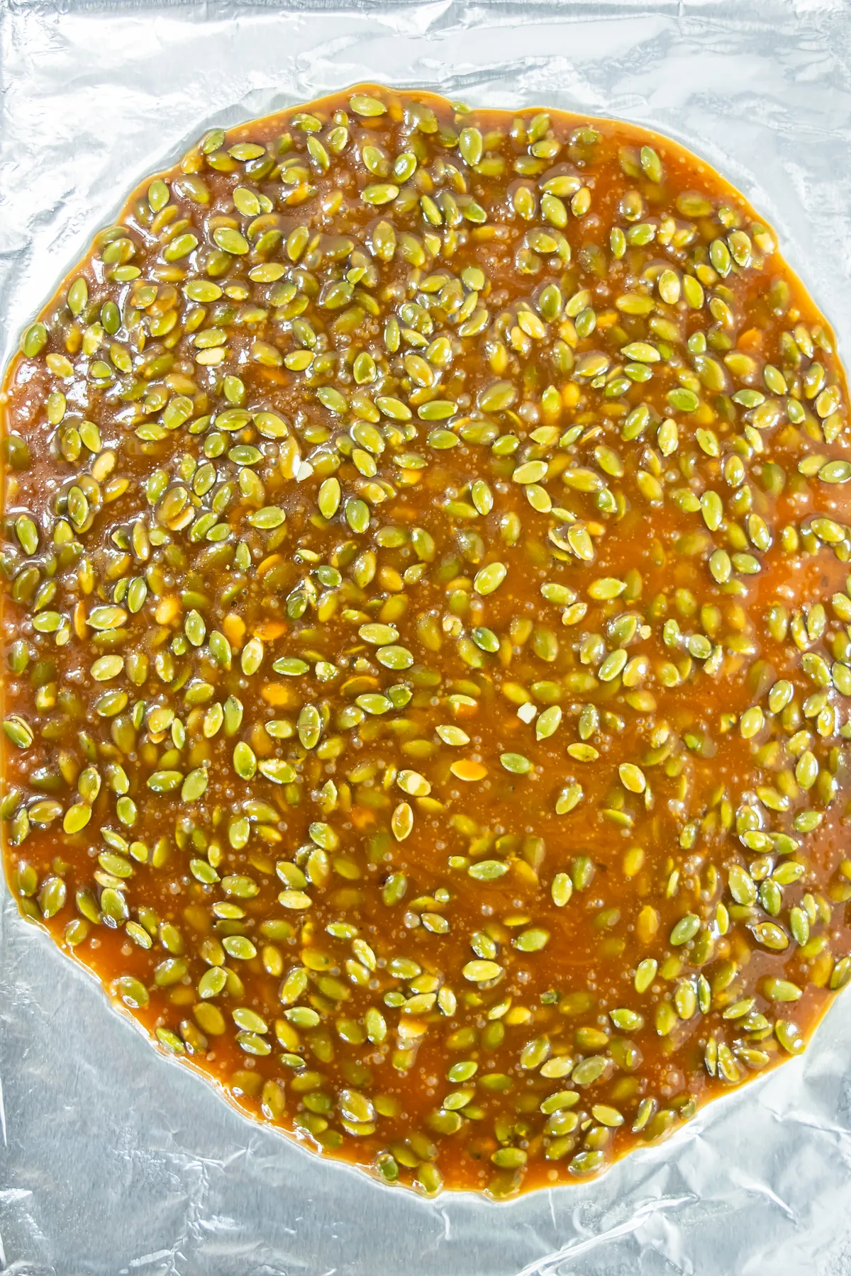 Hot pumpkin seed brittle spread thinly on a lined baking sheet to cool.