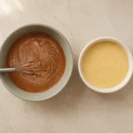 Vanilla batter and cinnamon cocoa batter in bowls before layering into a Bundt pan.