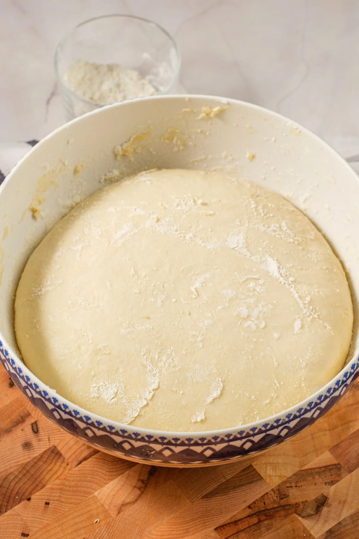 Pretzel dough risen until puffy in a large bowl.