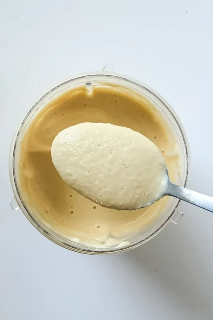 Creamy caramel crumble milkshake preparation in a blender.