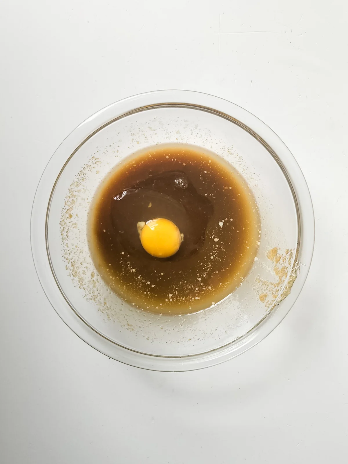 Egg added to the butter and brown sugar mixture for blondie batter.