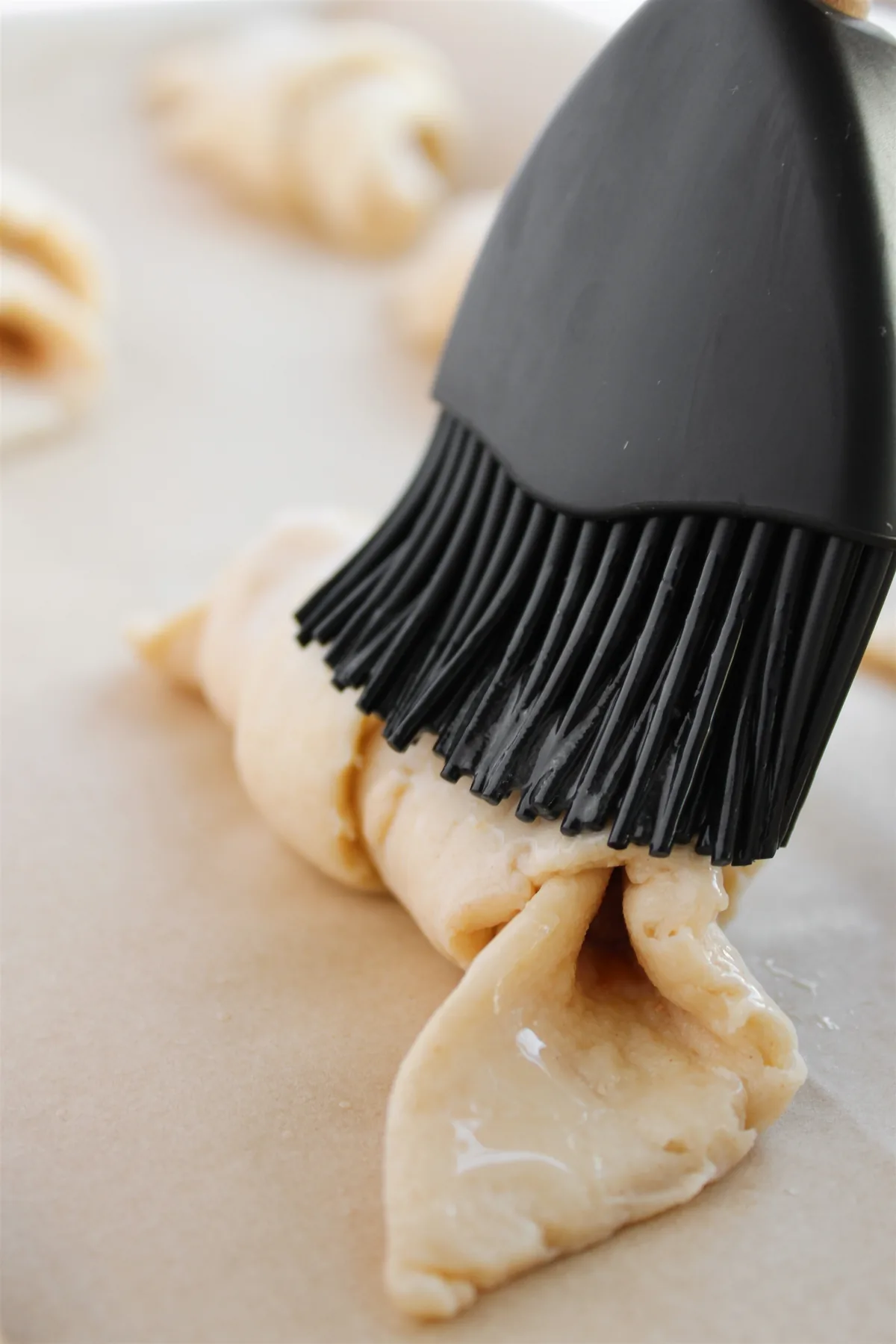 Easy Crescent Roll Churros With Dulce de Leche Brushing melted butter onto an unbaked crescent roll