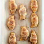 Easy Crescent Roll Churros With Dulce de Leche Baked crescent roll churros coated in cinnamon sugar on a baking sheet