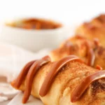 Easy Crescent Roll Churros With Dulce de Leche Close-up of a crescent roll churro with a dulce de leche drizzle